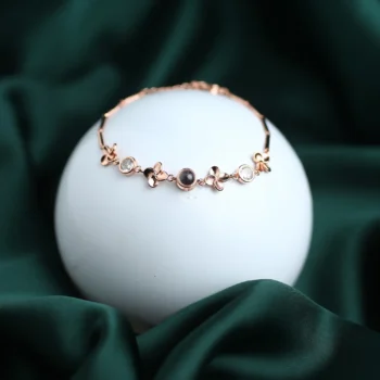 Clover bracelet with secret projection photo, a unique and sentimental jewelry piece.