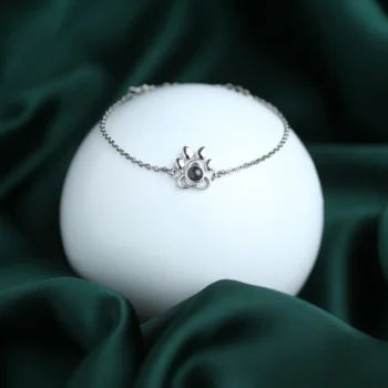 Paw print projection bracelet with hidden photo inside, a meaningful keepsake for pet lovers.