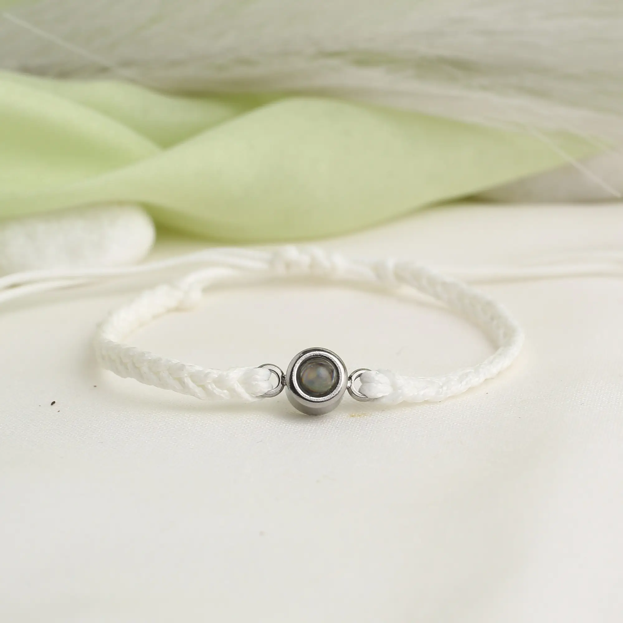 custom projection rope bracelet Minimalist cord bracelet holding a hidden photo projection, stylish keepsake jewelry.