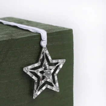 Elegant silver star ornament with picture inside, personalized holiday decoration and thoughtful gift.