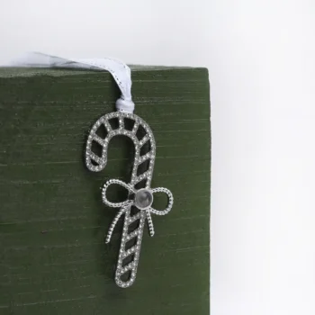 Holiday candy cane keepsake ornament with hidden photo, perfect for remembering special moments.