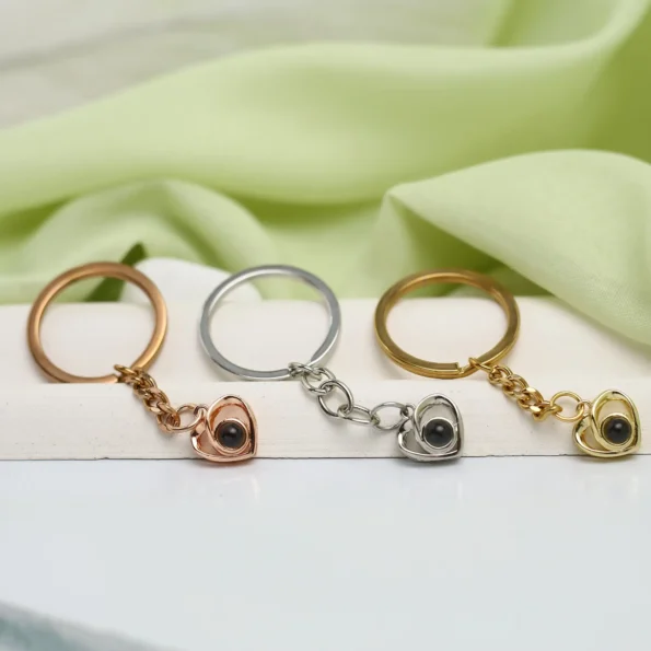 Crossed heart projection keychain with hidden image inside, a romantic keepsake gift.