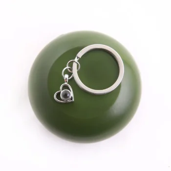 Personalized heart keychain with hidden image inside, unique and sentimental accessory.