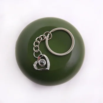 Shining heart projection keychain with hidden photo inside, a meaningful personalized keepsake.