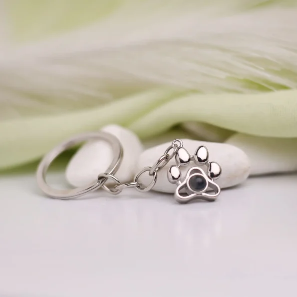 Pet paw photo projection keychain with hidden image, ideal for honoring cherished pets.