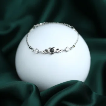 Angel heart bracelet with hidden photo inside, symbolizing love that feels close even when far apart.