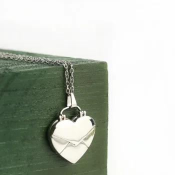 Matching heart necklaces with engraved hidden photos, a sentimental couple’s gift of love.