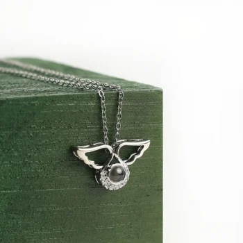 Angel wings necklace with hidden photo projection, representing comfort, peace, and eternal connection.