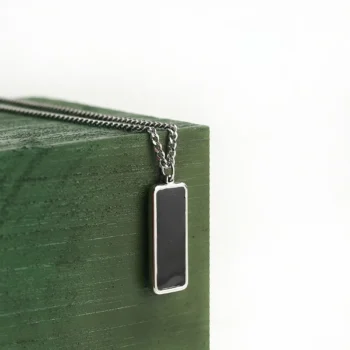 Bar heat necklace that reveals a hidden photo when warmed, a personalized keepsake of love.