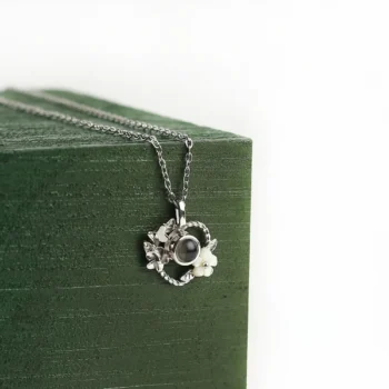 Personalized floral wreath necklace with hidden picture inside, a perfect anniversary or sentimental gift.