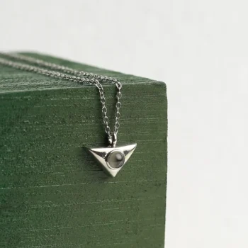 Personalized trinity knot pendant adorned with CZ stones and hidden photo projection, a timeless symbol of unbreakable bonds.