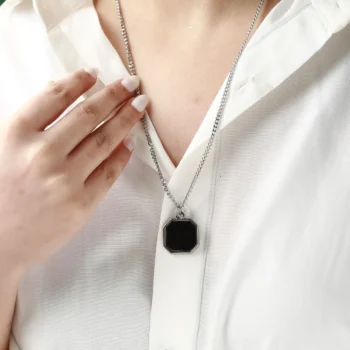 Personalized octagon heat necklace revealing a hidden photo through warmth, a heartfelt anniversary gift.