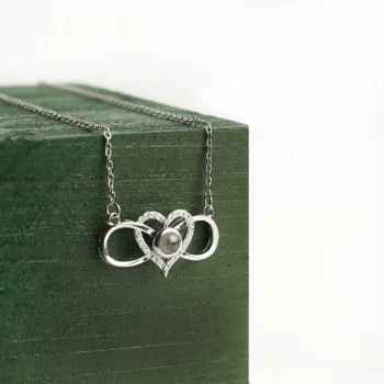 Infinity heart necklace with hidden projection image inside, representing everlasting bonds and timeless affection.