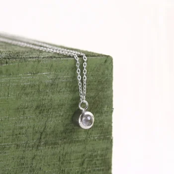 Personalized bubble pendant with secret image inside, delicate minimalist projection jewelry keepsake.