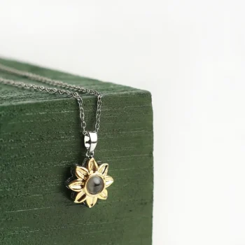 Custom golden bloom pendant featuring a hidden projection photo, a radiant symbol of love and connection.