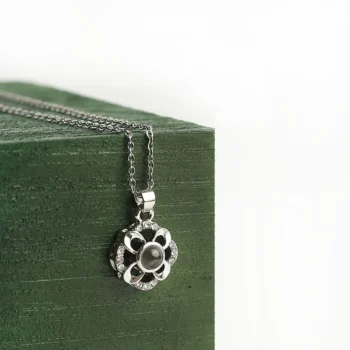 Custom petal halo pendant with hidden projection photo, a romantic symbol of love and light.